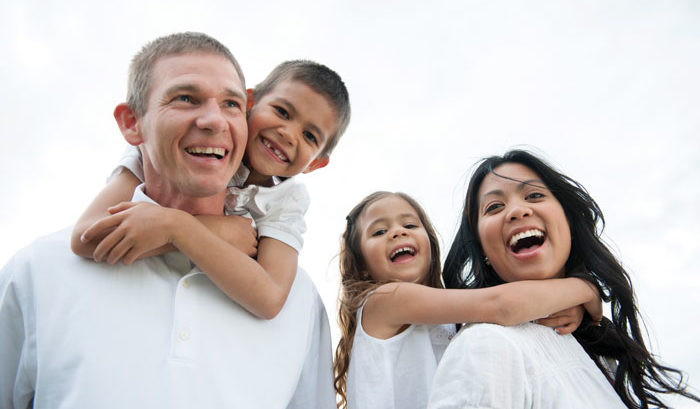 family in white smiling and happy about ancillary benefits