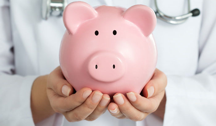 female doctor hands holding a pink piggy bank to symbolize health savings accounts or HSA