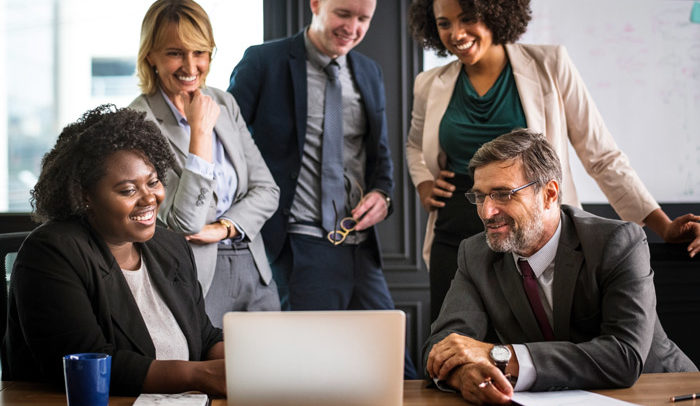 happy employees reviewing group health insurance costs