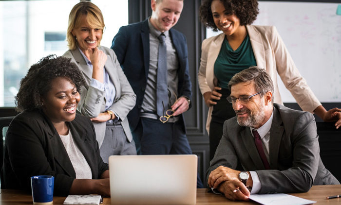 happy employees reviewing group health insurance costs